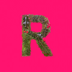 Festive, winter, christmas season natural pine, holly branches, red berries, unique collection of letters, numbers and symbols. Letter R