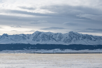 Rocky mountain range covered by snow. Mountains of Altai Republic