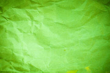 Obraz na płótnie Canvas Vignette green crumpled paper.