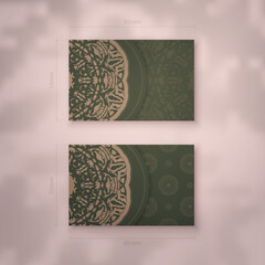 Business card template in green with Indian brown pattern for your brand.