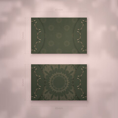 Business card template in green with Indian brown pattern for your business.