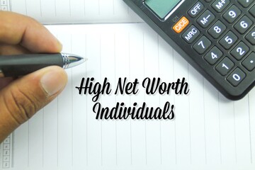 calculator, hand holding pen with the words high net worth individuals