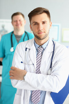 Two male medical workers in uniform at the workplace,