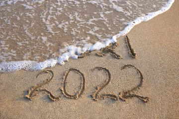 Foto op Canvas 2021, 2022 years written on sandy beach sea. Wave washes away 2021. © Viktoriia M