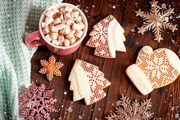 Christmas decorations, gingerbread, candle and garland on a wooden background