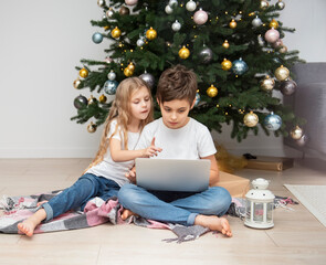 Children play near the Christmas tree.