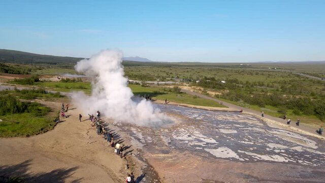 Aerial Cinematic footage of the Impressive Icelands Geysir Geisir in the Golden Circule, the geothermal activity and a attraction for tourists in Iceland	