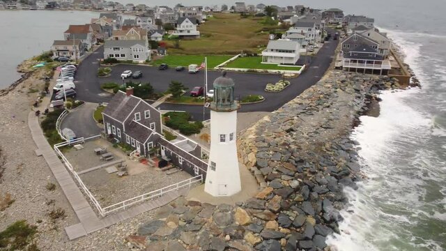 Orbital shot of a lighthouse tower seaside of the sea coast beach shoreline