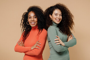 Two vivid smiling vivid young curly black women friends 20s wear casual shirts clothes stand back...