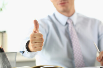 Man in the office shows ok gesture, close-up