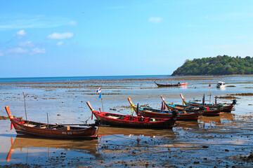 Rawai, Thailand- 02.03.2013: The wooden local traditional longtail fishing boats on sea beach in low tide time. 