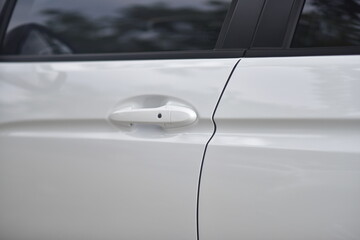 close up of white car door handle