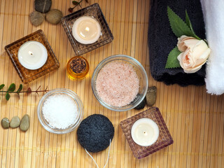 Home skin care. Himalayan salt, sea salt, almond oil, towels and candles. Flat lay