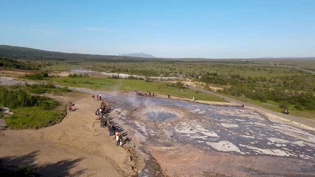 Aerial Cinematic footage of the Impressive Icelands Geysir Geisir in the Golden Circule, the geothermal activity and a attraction for tourists in Iceland	
