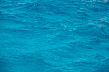 Abstract background. Waves of blue sea water. Copy space. Selective focus.