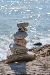 View of stone tower on the beach and sea as background