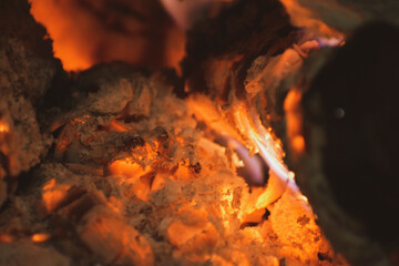 close-up Wooden firewood smolders in the fireplace