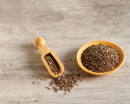 Bowl and wooden scoop with chia seeds