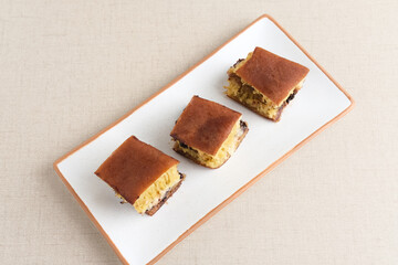 Martabak Manis or Kue Terang Bulan or Hok Lo Pan with various fillings is snack from Indonesia usually consumed at night. Served in white plate, selective focus image.

