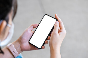A woman holding a cell phone with a blank white screen. The blank space on the white screen can be used to write a message or place an image.