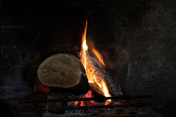 Fire in a fireplace in a rural house.