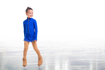 A Little young figure skater posing in blue training dress on ice on white background