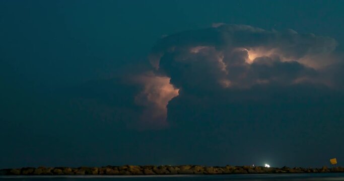 Timelapse video of lightning cloudscape night over the ocean horizon