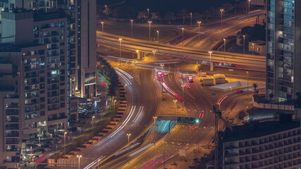 Fototapeta na wymiar Big crossroad junction between JLT district and Dubai Marina intersected by Sheikh Zayed Road aerial night timelapse.
