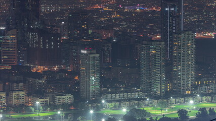 Fototapeta na wymiar Dubai Aerial view showing greens and al barsha heights district area night timelapse