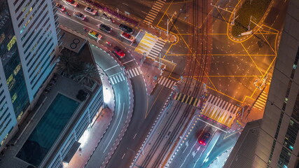 Aerial view of a road intersection between skyscrapers in a big city timelapse.