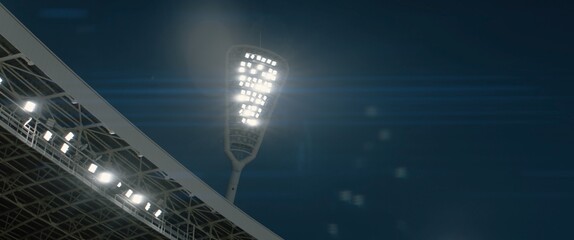 View of floodlights shining over large empty soccer stadium