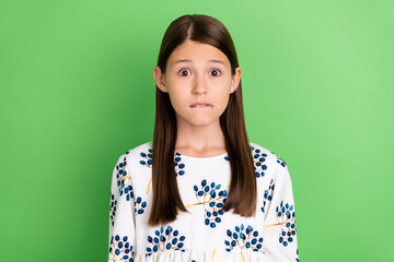 Fototapeta premium Portrait of anxious horrified schoolkid bite lips worry spring study exam isolated over green color background