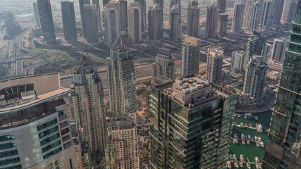 JLT and Dubai Marina skyscrapers intersected by Sheikh Zayed Road all day timelapse
