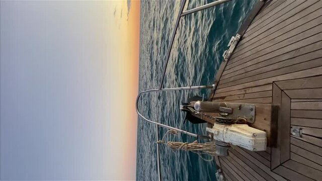 Vertical footage from the bow of the yacht yacht railings. The bow of the stern of the ship jumps strongly over the waves up and down