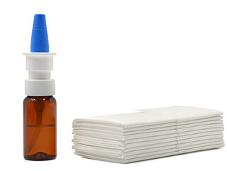 Nasal spray and a stack of paper tissues on a white background with copy space