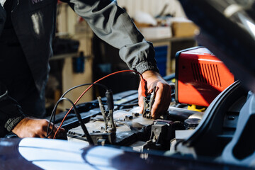 Car service, repair, maintenance concept. Close up of hands car electrician repairs car, tester and...