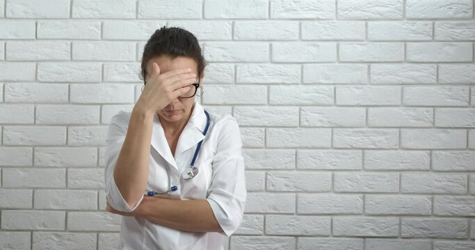 Stressed medical worker. A view of stressed medical worker stay in the room in sadness.