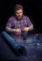 Leather Craftsman demonstrates leather cutting process