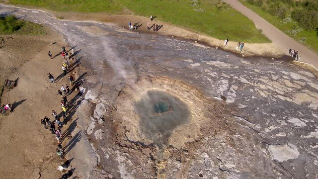 Aerial Cinematic footage of the Impressive Icelands Geysir Geisir in the Golden Circule, the geothermal activity and a attraction for tourists in Iceland	