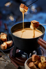 Croutons in cheese fondue in pot