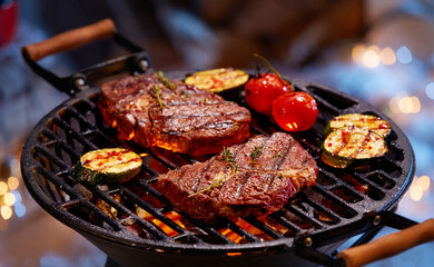 Steaks and vegetable preparing on grill - 472583834