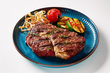 Appetizing steak with vegetables on plate