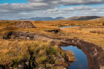 Peat bog production in Ireland for household heating needs. Warm sunny day, blue sky. Nobody. Traditional craft and energy source
