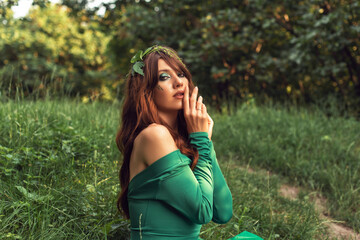 Young woman in green dress in the park