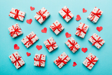 Fototapeta na wymiar Valentine day composition Background: red gift box with bow and heart. Christmas present. View from above. Holday greeting card