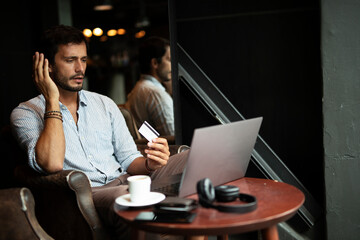 Handsome businessman working on laptop and sitting in cafe. Young student learning online.