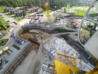 construction of a hotel with the help of tower cranes, in the mountains against the backdrop of...
