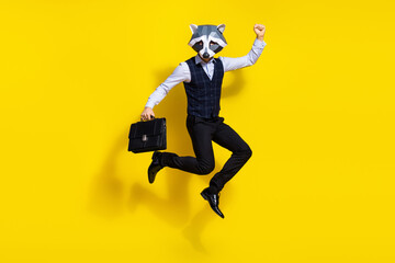 Full length photo of weird guy racoon mask hold bag raise fist up win lottery wear stylish trendy vest isolated yellow color background