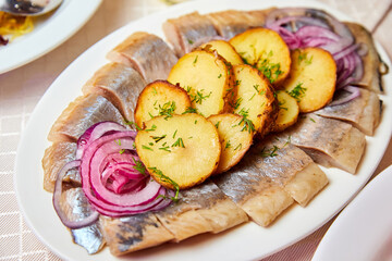 Russian New Year's dish. Herring with potatoes and sweet onions