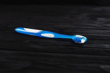blue toothbrush on a wooden background lying down